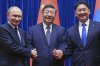 From left, Russian President Vladimir Putin, Chinese President Xi Jinping and Mongolian President Ukhnaagiin Khurelsukh shake hands during a family photo session ahead of their trilateral meeting in the Fujian Room at the Great Hall of the People in Beijing, China, Tuesday, Sept. 2, 2025. (Sergei Bobylev, Sputnik, Kremlin Pool Photo via AP)
