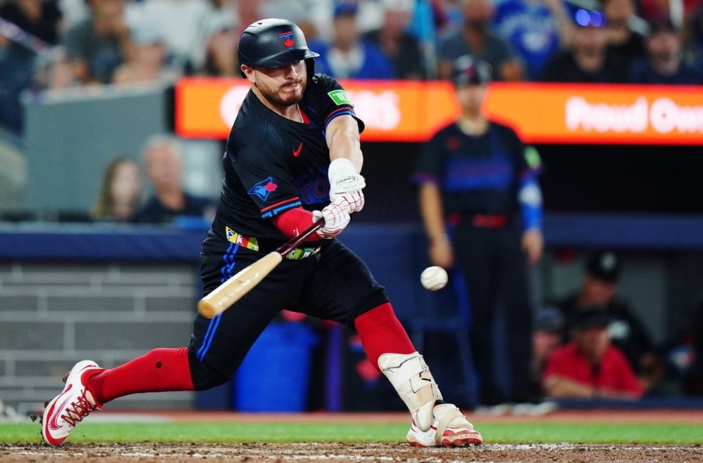 Toronto Blue Jays' Alejandro Kirk (30) hits a two-run single against the Texas Rangers during eighth inning MLB baseball action in Toronto on Friday, August 15, 2025. THE CANADIAN PRESS/Frank Gunn