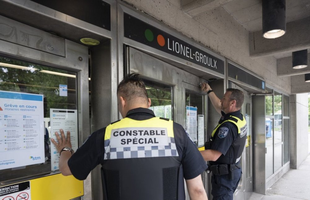 Special constables from the Société de transport de Montréal locking the doors to a metro station in Montreal, Monday, June 9, 2025. THE CANADIAN PRESS/Christinne Muschi