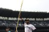 Seattle Mariners' Eugenio Suarez greets fans after the team's win in a baseball game against the San Diego Padres, Wednesday, Aug. 27, 2025, in Seattle. (AP Photo/Lindsey Wasson)
