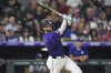 Colorado Rockies' Hunter Goodman follows the flight of his double to drive in two runs off Los Angeles Dodgers relief pitcher Jack Dreyer in the eighth inning of a baseball game, Wednesday, Aug. 20, 2025, in Denver. (AP Photo/David Zalubowski)