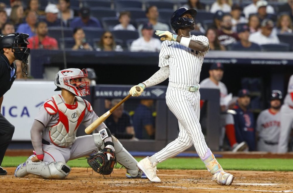 New York Yankees' Jazz Chisholm Jr. follows through on a two run home run during the second inning of a baseball game against the Boston Red Sox, Sunday, Aug. 24, 2025, in New York. (AP Photo/Noah K. Murray)