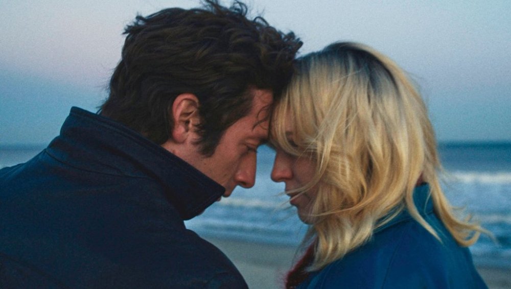 This image released by Disney shows Jeremy Allen White as Bruce Springsteen, left, and and Odessa Young as Faye, in a scene from