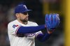 Texas Rangers starting pitcher Nathan Eovaldi prepares to deliver to the Arizona Diamondbacks in the first inning of a baseball game Monday, Aug. 11, 2025, in Arlington, Texas. (AP Photo/Tony Gutierrez)