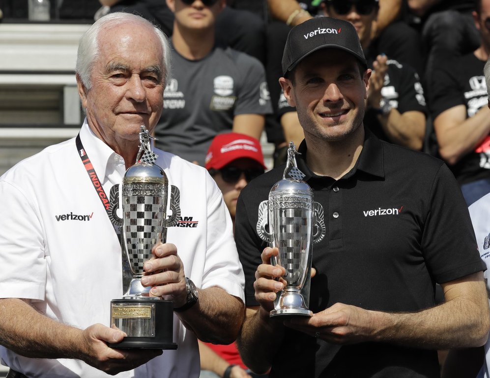 FILE - Car owner Roger Penske, left, and driver Will Power, of Australia, receive their
