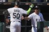 Chicago White Sox's Lenyn Sosa (50) is congratulated by manager Will Venable, right, after hitting a solo home run during the eighth inning of a baseball game against the New York Yankees in Chicago, Sunday, Aug. 31, 2025. (AP Photo/Nam Y. Huh)