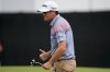 Keegan Bradley reacts to his birdie on the 18th green during the second round of the Tour Championship golf tournament, Friday, Aug. 22, 2025, in Atlanta. (AP Photo/Mike Stewart)