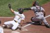 Pittsburgh Pirates' Isiah Kiner-Falefa (7) slides around the swipe tag attempt by San Francisco Giants catcher Andrew Knizner to score on a sacrifice fly by Tommy Pham during the fifth inning of a baseball game in Pittsburgh, Wednesday, Aug. 6, 2025. (AP Photo/Gene J. Puskar)