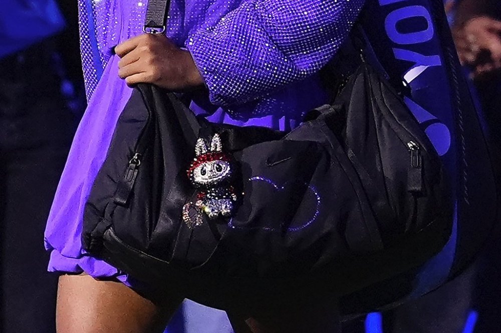 Naomi Osaka, of Japan, walks on the court with a Labubu doll hanging from her bag before playing against Amanda Anisimova, of the United States, during the women's singles semifinals of the U.S. Open tennis championships, Thursday, Sept. 4, 2025, in New York. (AP Photo/Yuki Iwamura)