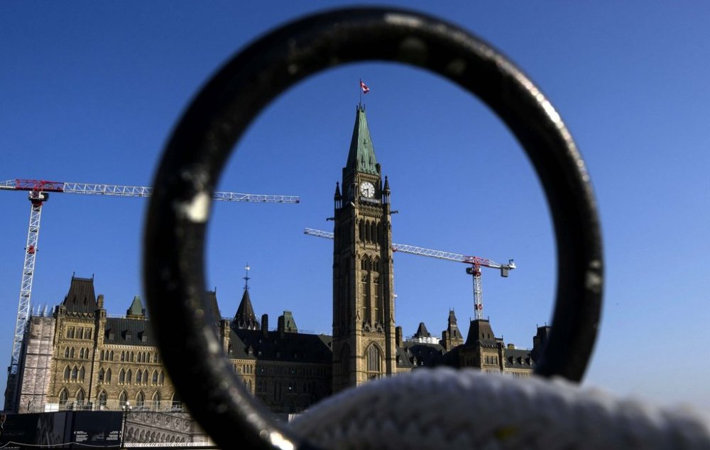 Centre Block and the Peace Tower are seen past a metal fence along the lawn of Parliament Hill in Ottawa on Thursday, Sept. 5, 2024. THE CANADIAN PRESS/Justin Tang