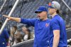 New York Mets manager Carlos Mendoza, left, talks with Brett Baty during batting practice before a baseball game against the Washington Nationals, Tuesday, Aug. 19, 2025, in Washington. (AP Photo/John McDonnell)