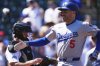 Los Angeles Dodgers' Freddie Freeman is congratulated as he crosses home plate after hitting a two-run home run off Colorado Rockies starting pitcher Chase Dollander in the first inning of a baseball game Thursday, Aug. 21, 2025, in Denver. (AP Photo/David Zalubowski)