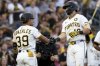 Pittsburgh Pirates' Jared Triolo, right, is greeted by Nick Gonzales, left, after hitting a two-run home run during the third inning of a baseball game against the Colorado Rockies, Saturday, Aug. 23, 2025, in Pittsburgh. (AP Photo/Matt Freed)