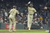 San Diego Padres' Jackson Merrill, right, is congratulated by third base coach Tim Leiper (33) after hitting a home run against the San Francisco Giants during the eighth inning of a baseball game in San Francisco, Tuesday, Aug. 12, 2025. (AP Photo/Jeff Chiu)