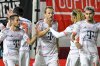 Bayern Munich's Harry Kane, center, is congratulated after scoring from the penalty spot against SV Wehen Wiesbaden during the DFB Pokal, Germany Cup, soccer match, Wednesday, Aug 27, 2025, in Wiesbaden, Germany. (Uwe Anspach/dpa via AP)