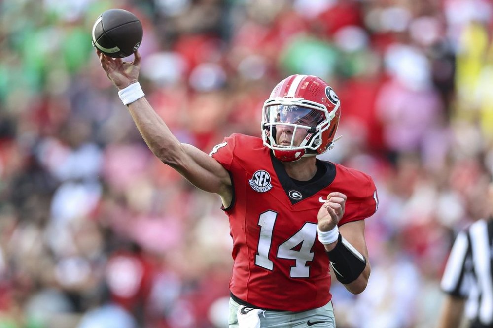 Georgia quarterback Gunner Stockton (14) throws a pass during the first half of an NCAA college football game against Marshall, Saturday, Aug. 30, 2025, in Athens, Ga. (AP Photo/Colin Hubbard)