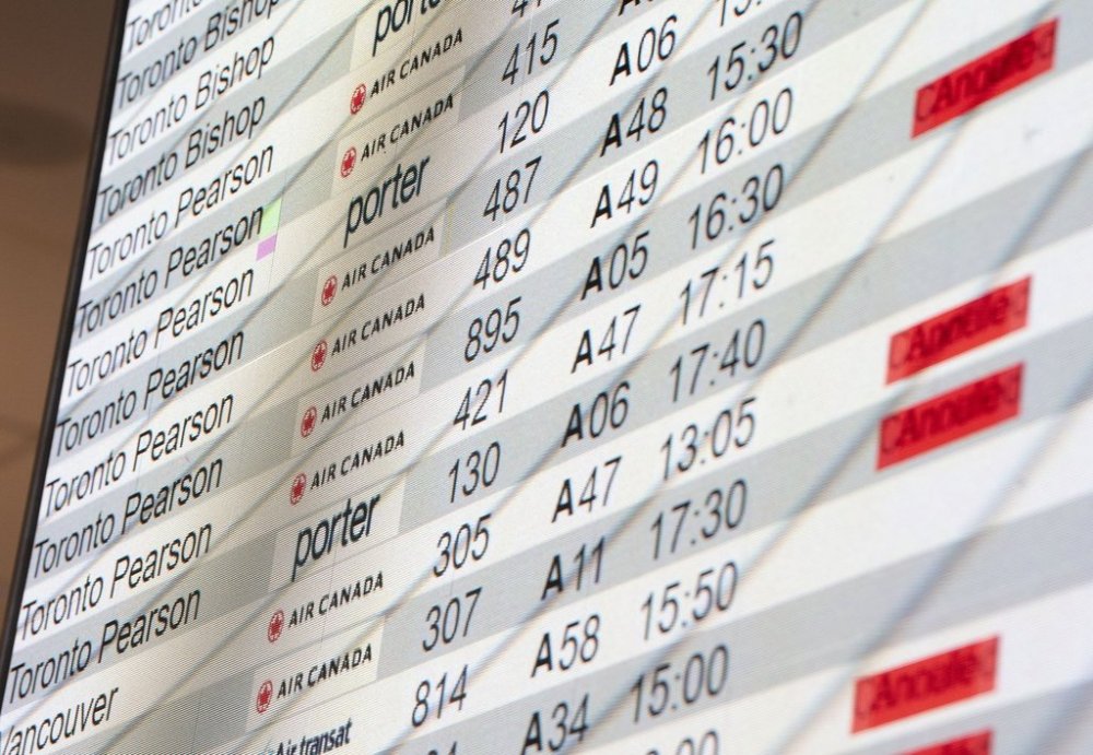 A departure board is seen at Montreal-Pierre Elliott Trudeau International Airport in Dorval, Que., on Tuesday, Aug. 19, 2025. THE CANADIAN PRESS/Christinne Muschi