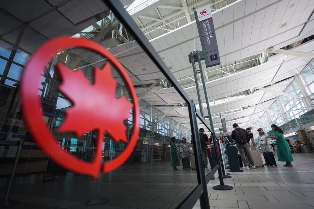 Passengers use a kiosk to check in for an Air Canada flight at Vancouver International Airport, in Richmond, B.C., on Wednesday, Aug. 13, 2025. Air Canada is preparing to gradually suspend flights ahead of a potential work stoppage on Saturday. The airline said the first flights will be cancelled Thursday, with more on Friday and a complete cessation of flying by Air Canada and Air Canada Rouge by the weekend if it doesn't reach a last-minute deal with the flight attendants' union. THE CANADIAN PRESS/Darryl Dyck