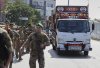 Lebanese army soldiers escort trucks carrying weapons handed over by Palestinian factions from Rashidiyeh refugee camp to the Lebanese army, as they pass in Tyre city, south Lebanon, Thursday, Aug. 28, 2025. (AP Photo/Mohammed Zaatari)