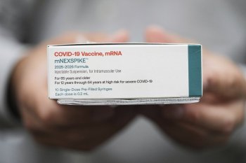Co-owner Marc Ost at Eric's Rx Shoppe holds a box of COVID-19 vaccines as he unpacks a shipment in Horsham, Pa., Tuesday, Sept. 2, 2025. (AP Photo/Matt Rourke)