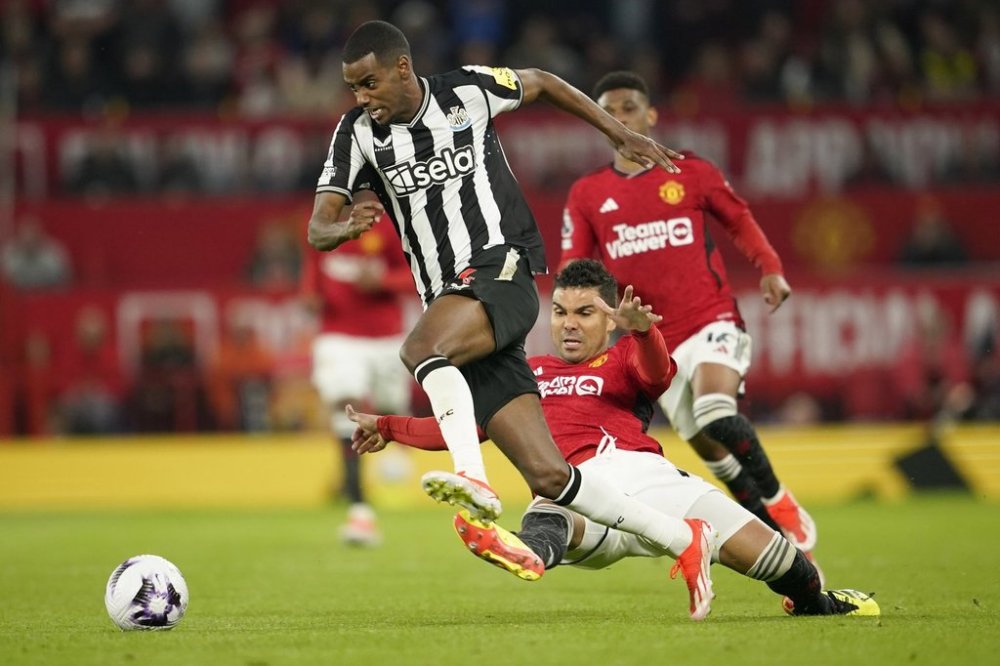 FILE - Newcastle's Alexander Isak, center, challenges for the ball with Manchester United's Casemiro during the English Premier League soccer match between Manchester United and Newcastle United, in Manchester, England, Wednesday, May 15, 2024. (AP Photo/Dave Thompson, File)