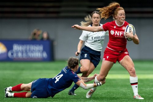 France's Marine Menager grabs Canada's Alex Tessier's leg as she runs the ball during WXV 1 women's rugby union action, in Vancouver, Sunday, Sept. 29, 2024. Canadian Tessier is a finalist for World Rugby's Women’s 15s Player of the Year. THE CANADIAN PRESS/Ethan Cairns