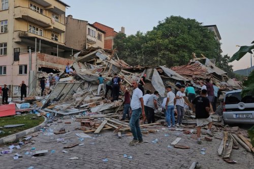People remove the wreckage of a collapsed building following an earthquake in Sindirgi, northwest Turkey, Sunday, Aug. 10, 2025. (Bahadir Demirceviren/IHA via AP)