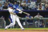 Kansas City Royals' Bobby Witt Jr. hits a two-run home run for his 100th career home run during the eighth inning of a baseball game against the Texas Rangers, Tuesday, Aug. 19, 2025, in Kansas City, Mo. (AP Photo/Charlie Riedel)