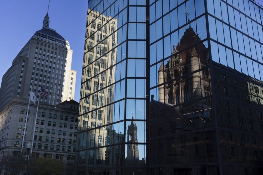 FILE - Buildings are reflected in 200 block of Clarendon Street, Nov. 8, 2022, in Boston. (AP Photo/Michael Dwyer, File)