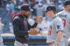 Minnesota Twins' Byron Buxton, left, congratulates Alan Roden (19) at the end of a baseball game against the Cleveland Guardians, Sunday, Aug. 3, 2025, in Cleveland. (AP Photo/Phil Long)