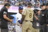 Los Angeles Dodgers manager Dave Roberts, second from left, greets San Diego Padres manager Mike Shildt prior to a baseball game Friday, Aug. 15, 2025, in Los Angeles. (AP Photo/Mark J. Terrill)