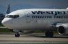 Pilots taxi a WestJet Boeing 737-700 aircraft to the runway for departure from Vancouver International Airport in Richmond, B.C., on Friday, May 19, 2023.  THE CANADIAN PRESS/Darryl Dyck