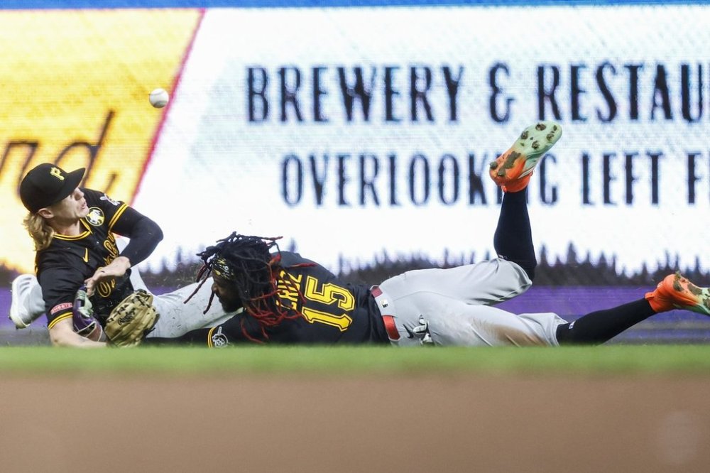 Pittsburgh Pirates' Jack Suwinski, left, and Oneil Cruz can't catch a double by the Milwaukee Brewers' Joey Ortiz during the fourth inning of a baseball game, Tuesday, Aug.12, 2025, in Milwaukee. (AP Photo/Jeffrey Phelps)