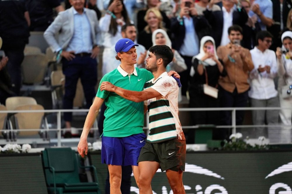 FILE - Winner Spain's Carlos Alcaraz, right, and Italy's Jannik Sinner hug after the final match of the French Tennis Open at the Roland-Garros stadium in Paris, June 8, 2025. (AP Photo/Thibault Camus, File)