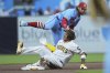 St. Louis Cardinals second baseman Brendan Donovan, above, tags out San Diego Padres' Manny Machado, as he was caught advancing to second off an RBI single during the first inning of a baseball game Saturday, Aug. 2, 2025, in San Diego. (AP Photo/Gregory Bull)