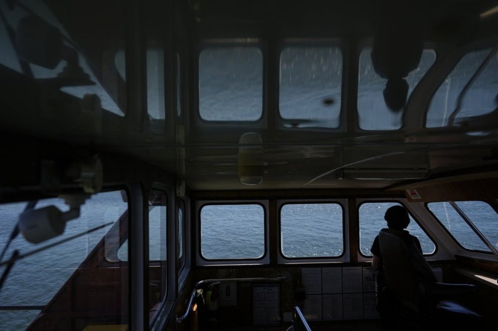Expedition 501 member Verena Heuer looks out from the bridge of the Gaspee, a crew transport vessel, as it travels along Sakonnet River near Portsmouth, R.I., during the eight-hour trip to the Liftboat Robert platform in the North Atlantic, Saturday, July 19, 2025. (AP Photo/Carolyn Kaster)