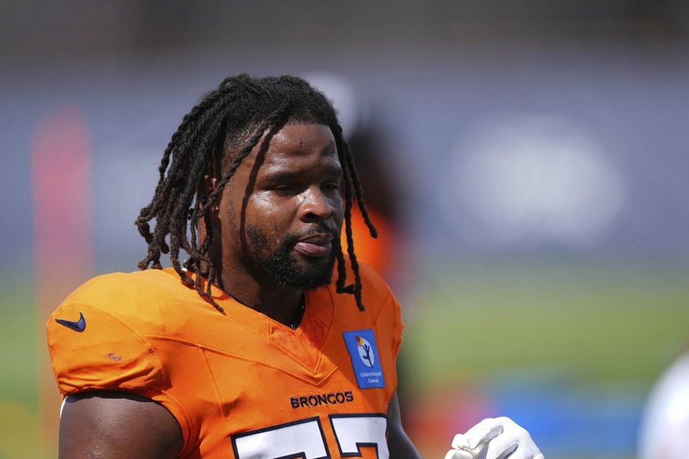 FILE - Denver Broncos linebacker Dre Greenlaw (57) warms up at an NFL football training practice July 28, 2025, in Centennial, Colo. (AP Photo/David Zalubowski, File)