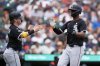 Chicago White Sox's Chase Meidroth, left, and Michael A. Taylor, right, celebrate after they scored off a single hit by Lenyn Sosa during the eighth inning of a baseball game against the Detroit Tigers, Sunday, Sept. 7, 2025, in Detroit. (AP Photo/Ryan Sun)
