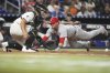 St. Louis Cardinals' Nolan Gorman, right, beats the throw to score on a single by Pedro Pages during the eighth inning of a baseball game against the Miami Marlins, Monday, Aug. 18, 2025, in Miami. (AP Photo/Lynne Sladky)