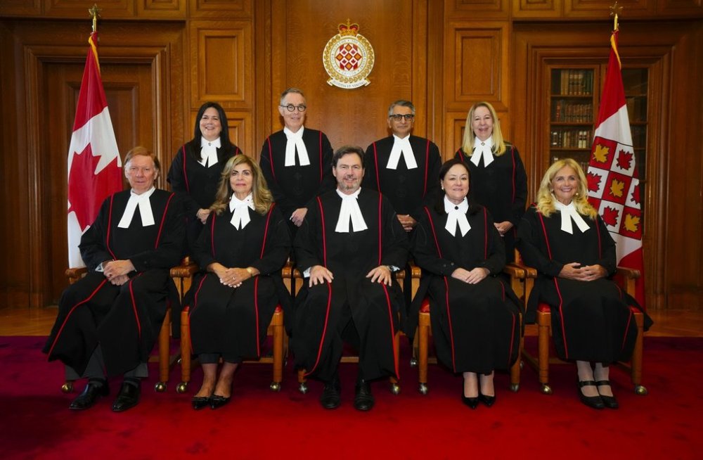 Supreme Court of Canada Justices Malcolm Row, left to right, Michelle O'Bonsawin, Andromache Karakatsanis, Nicholas Kasirer, Richard Wagner, Mahmud Jamal, Suzanne Cote, Mary T. Moreau, and Sheilah L. Martin wear their new robes as they take part in the Official Bench Photo in the Judges' Conference Room at the Supreme Court of Canada in Ottawa on Monday, Oct. 6, 2025. THE CANADIAN PRESS/Sean Kilpatrick