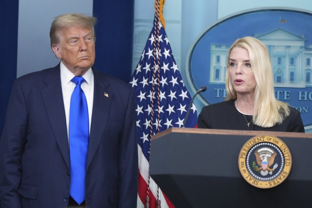 FILE - Attorney General Pam Bondi speaks to reporters as President Donald Trump listens, Friday, June 27, 2025, in the briefing room of the White House in Washington. (AP Photo/Jacquelyn Martin, File)