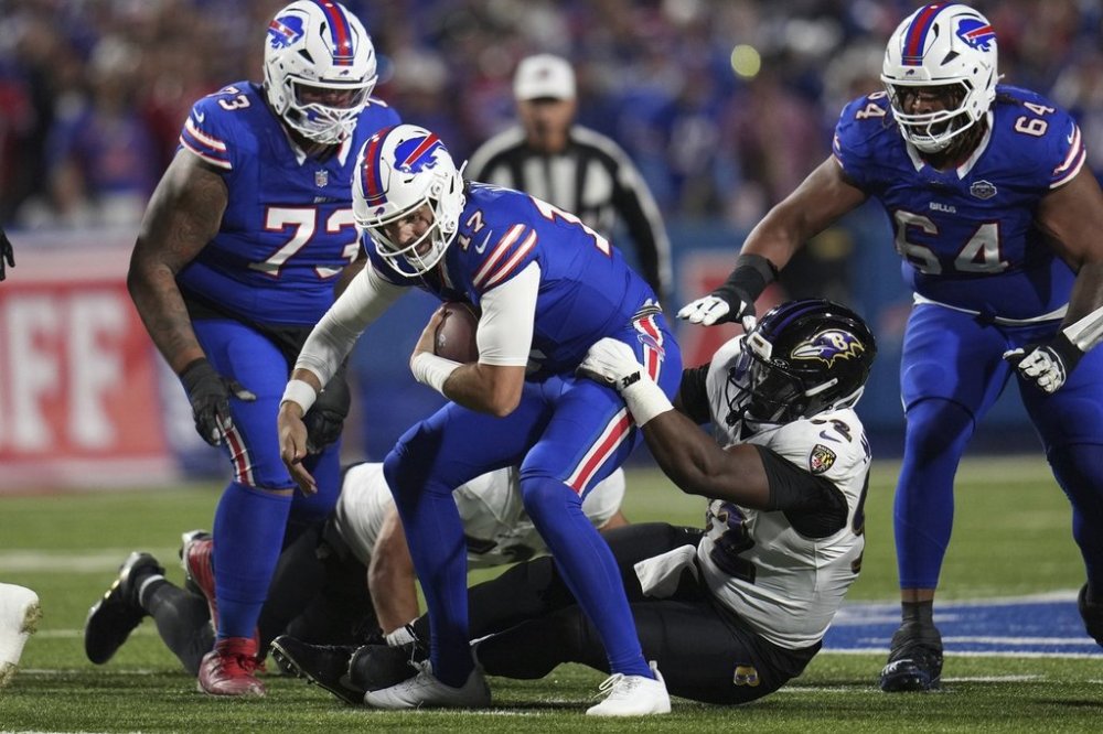 Buffalo Bills quarterback Josh Allen (17) is tackled by Baltimore Ravens defensive tackle Nnamdi Madubuike (92) during the first half of an NFL football game in Orchard Park, N.Y., Sunday, Sept. 7, 2025. (AP Photo/Gene J. Puskar)