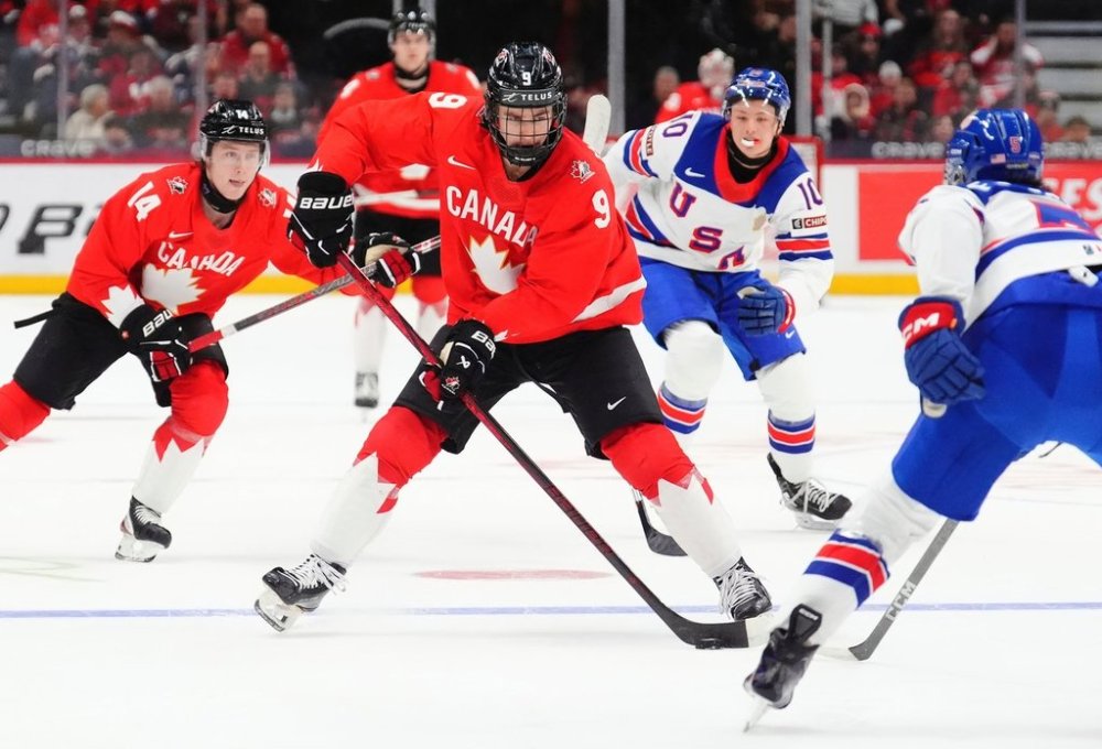 FILE — Canada's Gavin McKenna (9) skates with the puck as United States' Drew Fortescue (5) defends during the second period of an IIHF World Junior Hockey Championship tournament game in Ottawa, Ontario, Dec. 31, 2024. (Sean Kilpatrick/The Canadian Press via AP, File)
