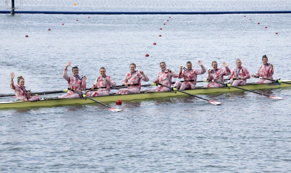 Canadian women's eights rowing crew celebrate after winning silver in the event at the Summer Olympics, Saturday, Aug. 3, 2024, in Vaires-sur-Marne, France. THE CANADIAN PRESS/Adrian Wyld