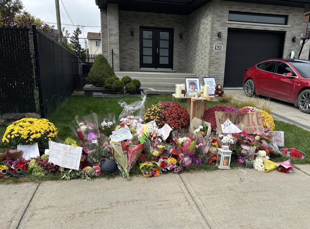 Flowers are left on the sidewalk in front of a home where a teenager was killed in an interaction with police in Longueuil, Que., south of Montreal on Wednesday Set. 24, 2025. Nooran Rezayi was killed on Sunday afternoon after police responded to a report of a group of armed people. THE CANADIAN PRESS/Sidhartha Banerjee