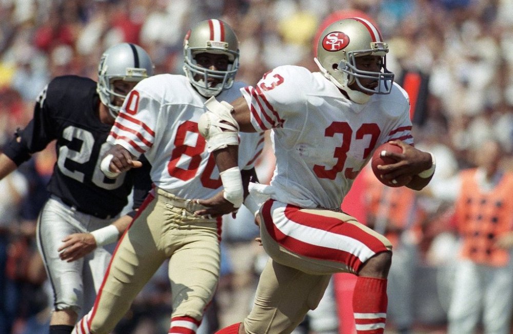 FILE - San Francisco 49ers Roger Craig (33) heads for the end zone and first quarter touchdown during an NFL football game against the Los Angeles Raiders at the Coliseum in Los Angeles, Sunday, Sept. 22, 1985. (AP Photo/Doug Pizac, File)