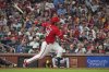 St. Louis Cardinals' Nolan Arenado following through on a three-run double before advancing to third on the throw during the fifth inning of a baseball game against the Milwaukee Brewers Friday, Sept. 19, 2025, in St. Louis. (AP Photo/Jeff Roberson)