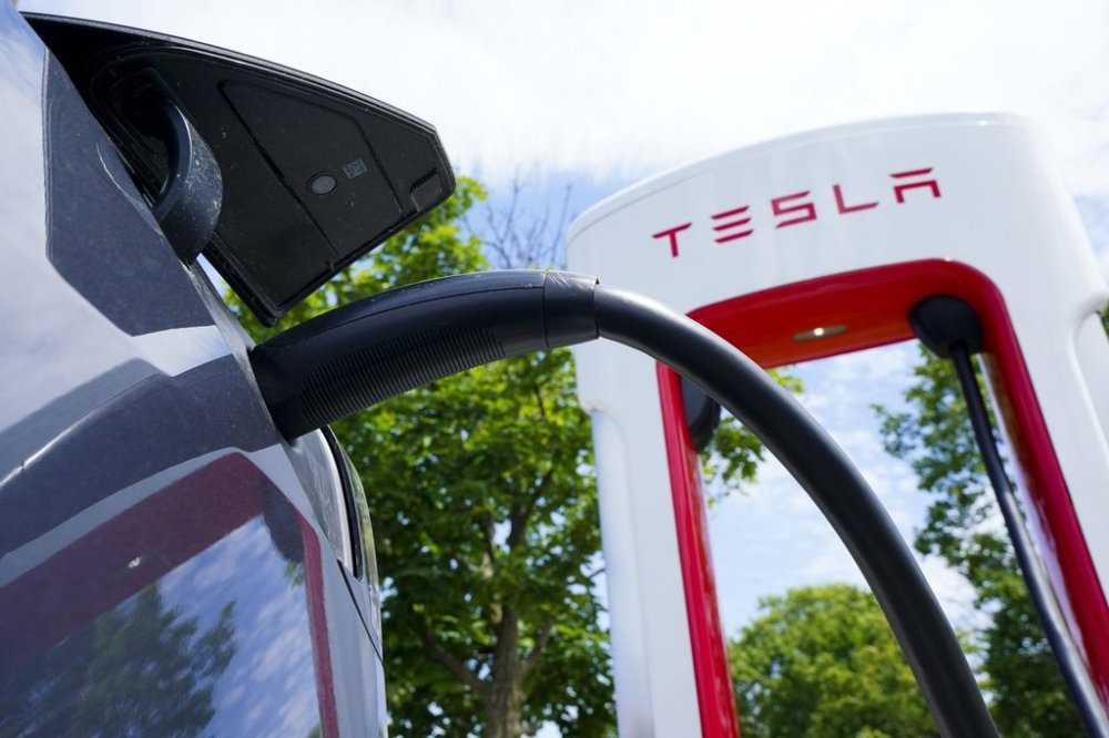 An electric vehicle is charged at a Tesla charging station in Ottawa on Wednesday, July 13, 2022. THE CANADIAN PRESS/Sean Kilpatrick