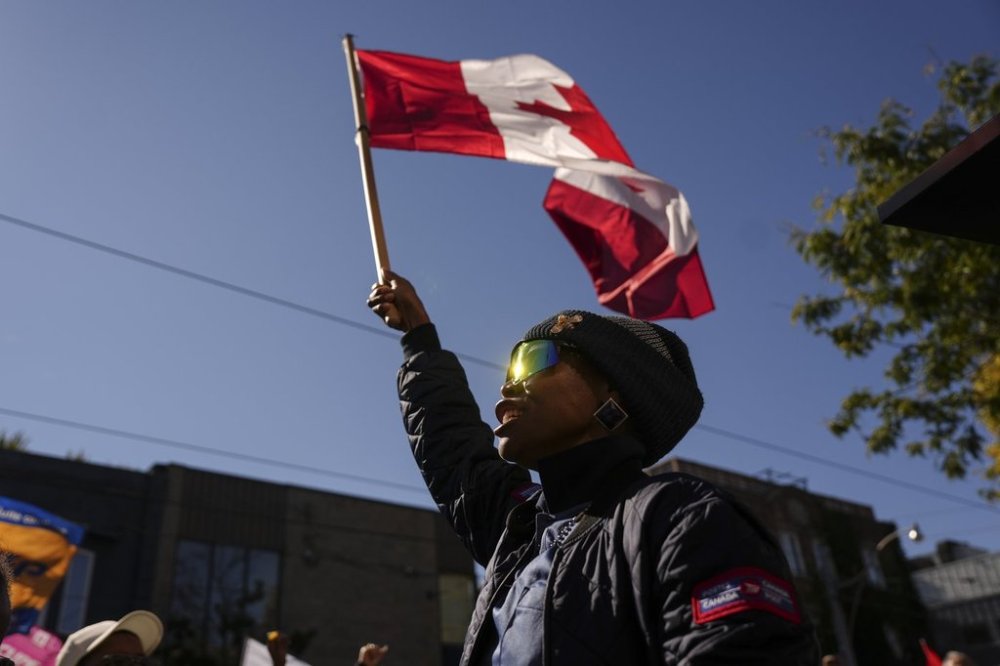 Canada Post workers are joined by CUPE union members as they hold a rally outside MP Julie Dabrusin's office in Toronto on Wednesday, Oct. 1, 2025. THE CANADIAN PRESS/Chris Young