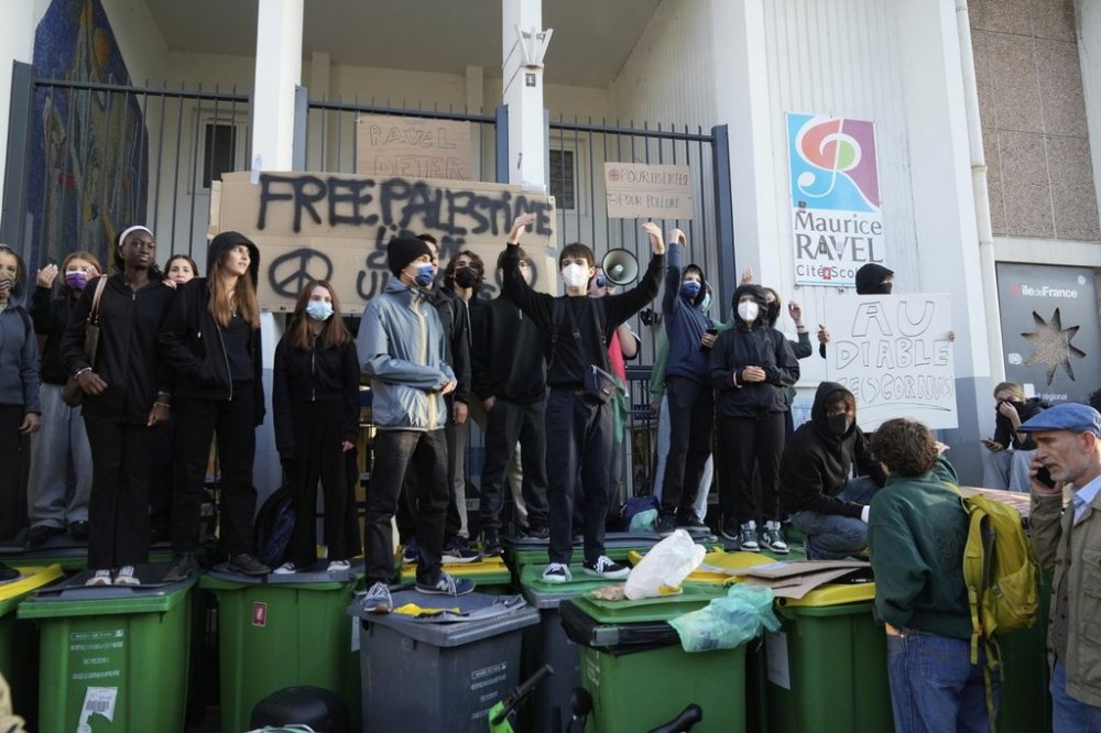 Students block the entrance of a school during a protest called by major trade unions to oppose budget cut, in Paris, France, Thursday, Sept. 18, 2025. (AP Photo/Michel Euler)